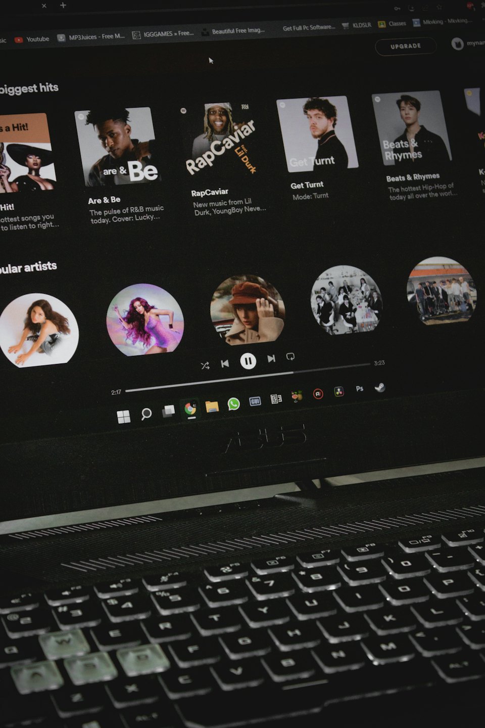 Laptop screen showing a music streaming service and open browser tabs.