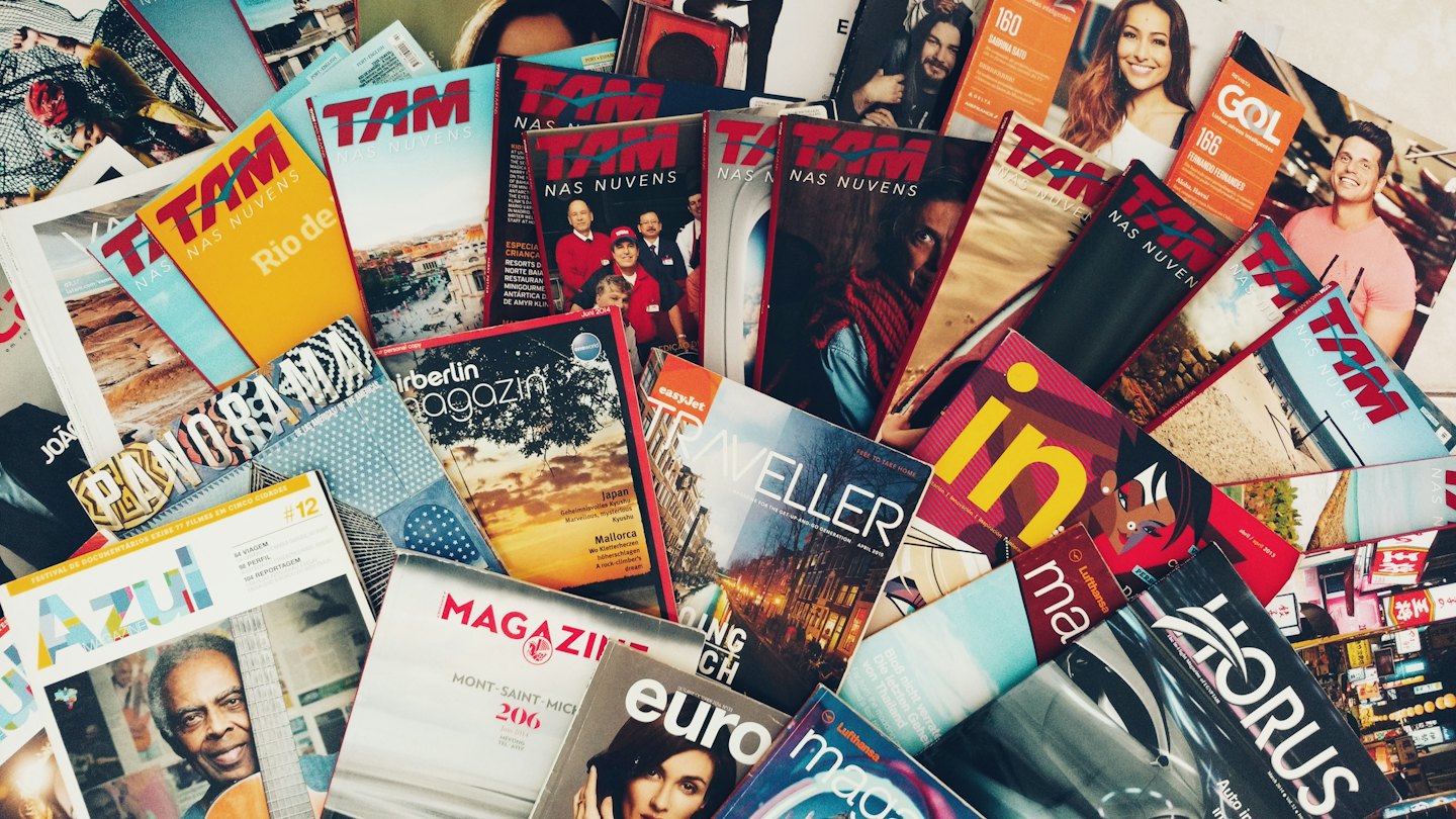 A pile of diverse magazine issues with people on the covers.